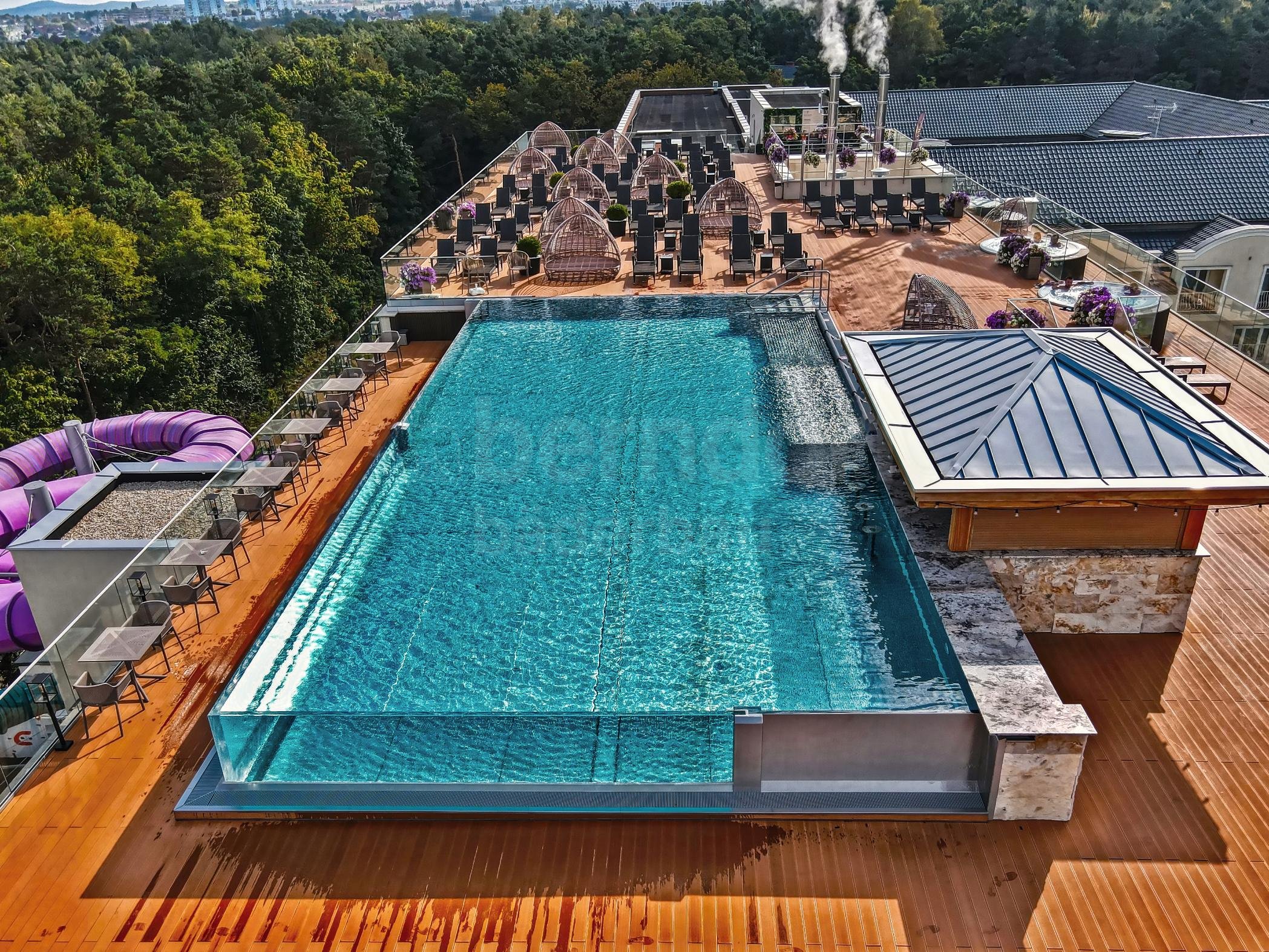 Hotel rooftop pool with infinity glass overflow gutter Hotel rooftop pool with infinity glass overflow gutter