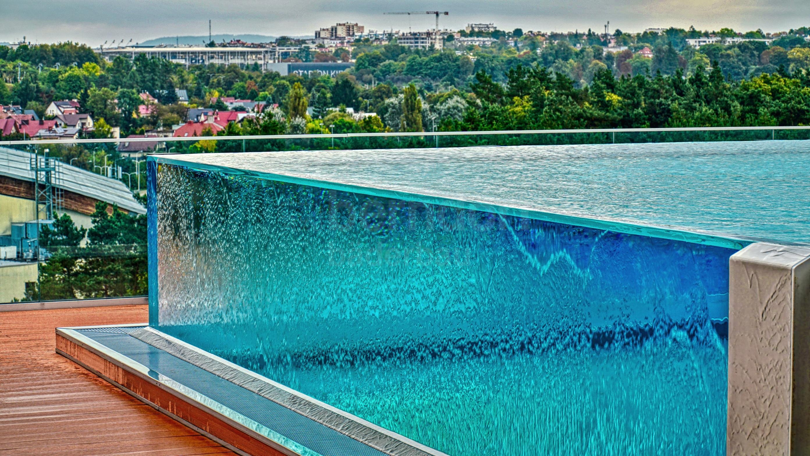 Hotel rooftop pool with infinity glass overflow gutter